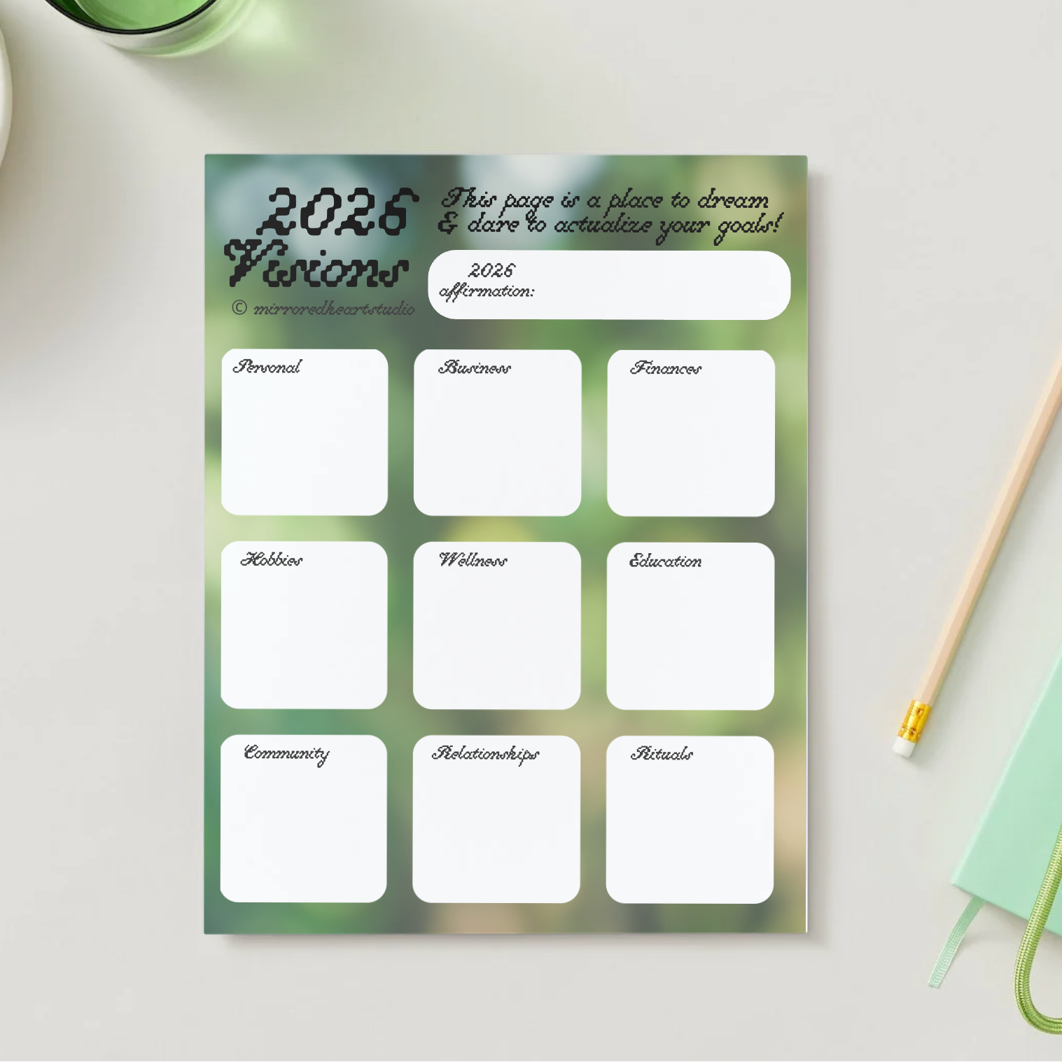 2026 Visions planner sheet on a table with a bowl of grapes and a pen.